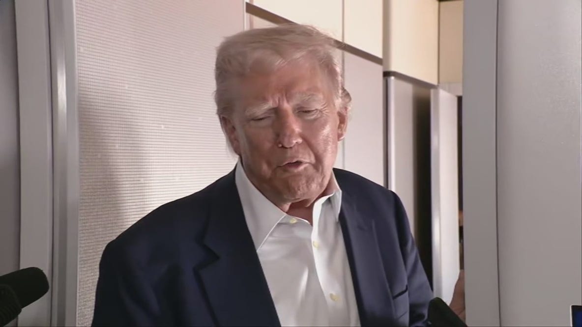 President Donald Trump answers questions on-board Air Force 1